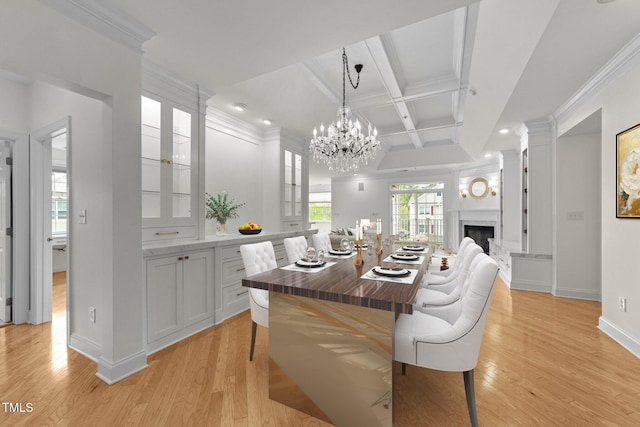 dining space with light wood finished floors, coffered ceiling, recessed lighting, and crown molding