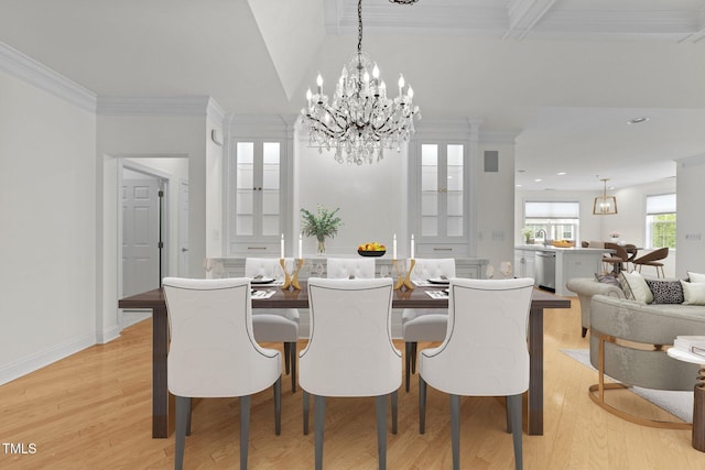 dining space featuring an inviting chandelier, light wood-style flooring, baseboards, and ornamental molding