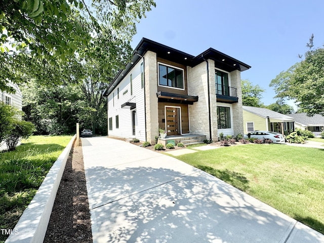 622 Glascock St, Raleigh, NC 27604 - contemporary house with a balcony, a front lawn, stone siding, and driveway