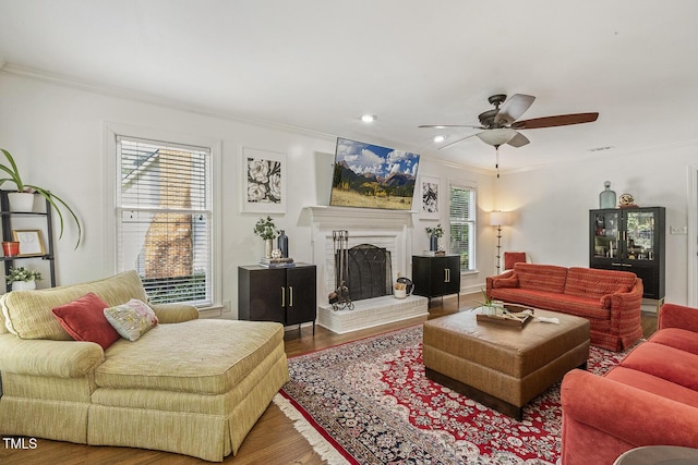 105 Cavendish Dr, Cary, NC 27513 - living room featuring ornamental molding, wood finished floors, a ceiling fan, a brick fireplace, and recessed lighting