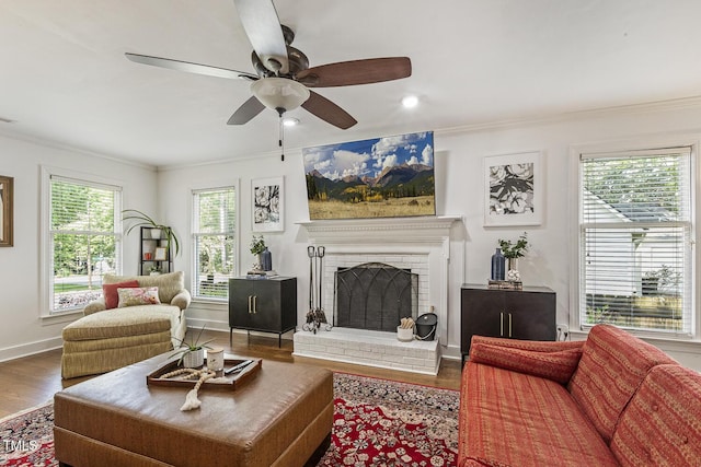 105 Cavendish Dr, Cary, NC 27513 - living room with crown molding, wood finished floors, a ceiling fan, a fireplace, and baseboards