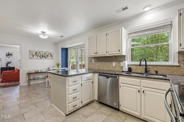 105 Cavendish Dr, Cary, NC 27513 - kitchen with appliances with stainless steel finishes, a sink, a peninsula, ornamental molding, and decorative backsplash