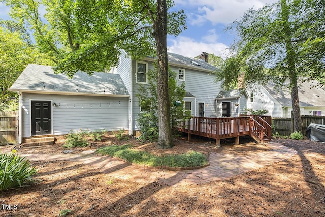 105 Cavendish Dr, Cary, NC 27513 - rear view of property featuring a wooden deck, a chimney, and a shingled roof
