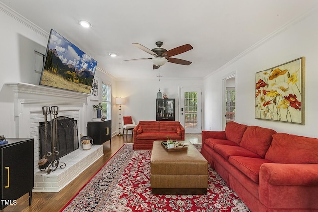 105 Cavendish Dr, Cary, NC 27513 - living room with crown molding, ceiling fan, wood finished floors, a fireplace, and recessed lighting
