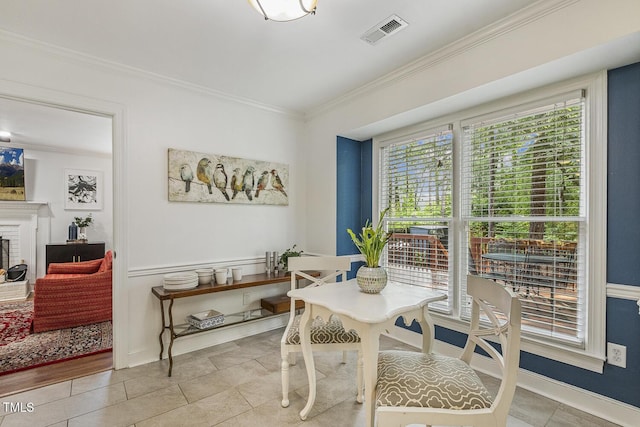 105 Cavendish Dr, Cary, NC 27513 - dining room with ornamental molding, plenty of natural light, light tile patterned floors, a brick fireplace, and baseboards