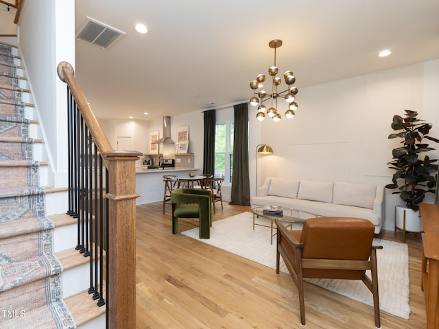 612 E Ellerbee St, Durham, NC 27704 - living room featuring light wood-style flooring, stairway, a chandelier, and recessed lighting