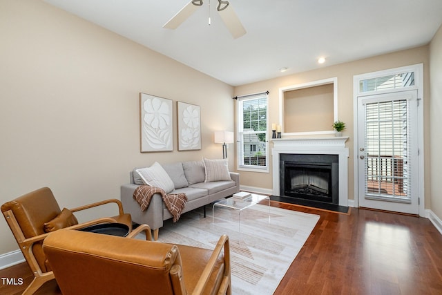 living room with wood finished floors, a fireplace, baseboards, ceiling fan, and recessed lighting