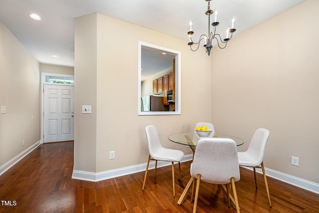dining area with a chandelier, wood finished floors, baseboards, and recessed lighting