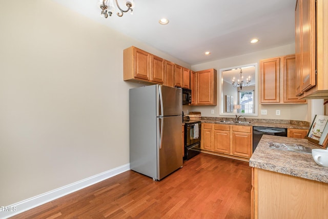 kitchen with black appliances, a chandelier, a sink, dark wood-style floors, and recessed lighting