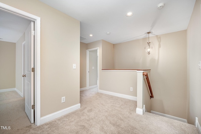 hall featuring an upstairs landing, carpet floors, baseboards, and recessed lighting
