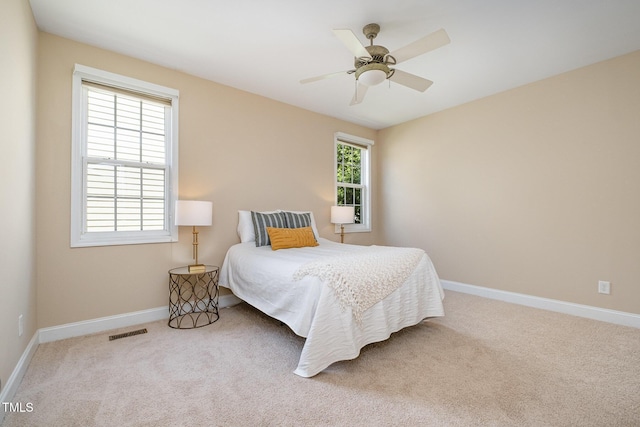 bedroom featuring carpet, baseboards, and a ceiling fan