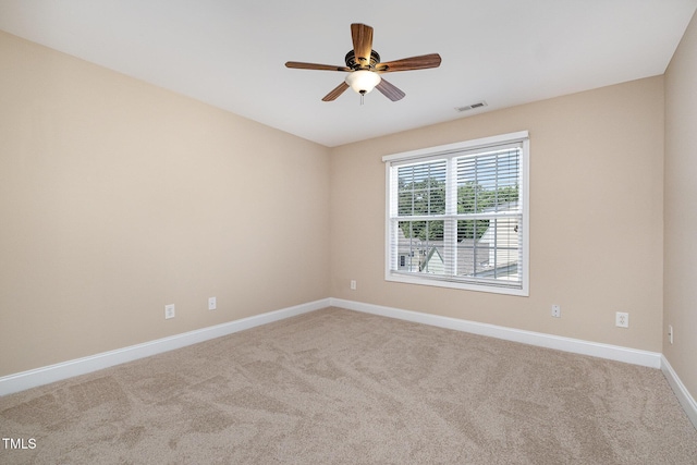 empty room featuring ceiling fan, baseboards, and carpet flooring