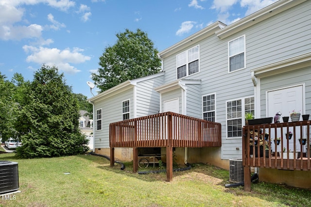back of house with a wooden deck, central AC unit, and a yard