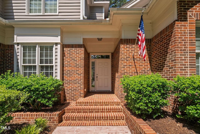 entrance to property with brick siding