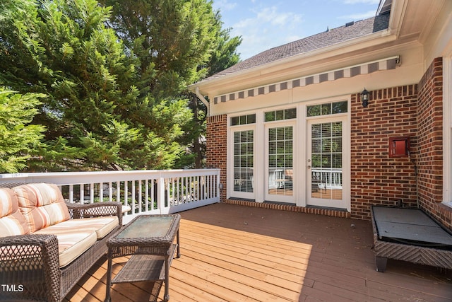 wooden deck with an outdoor living space