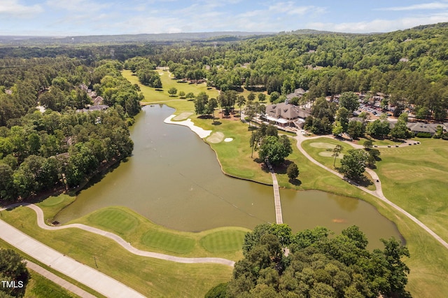 aerial view featuring a view of trees, view of golf course, and a water view