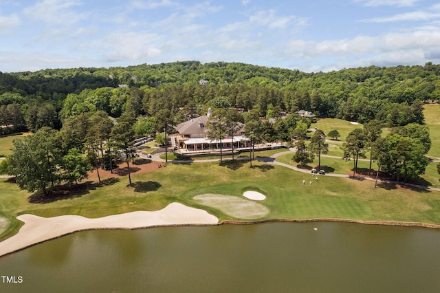 birds eye view of property with a water view, a view of trees, and golf course view