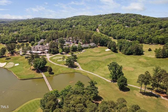 bird's eye view with a forest view, view of golf course, and a water view