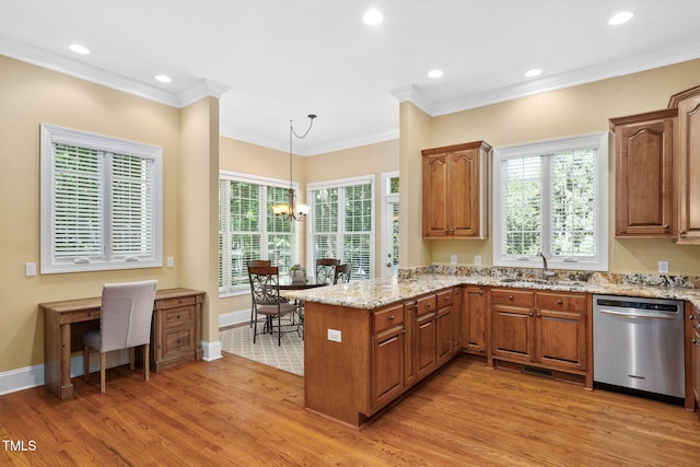 kitchen featuring dishwasher, a sink, light stone counters, a peninsula, and light wood-style flooring