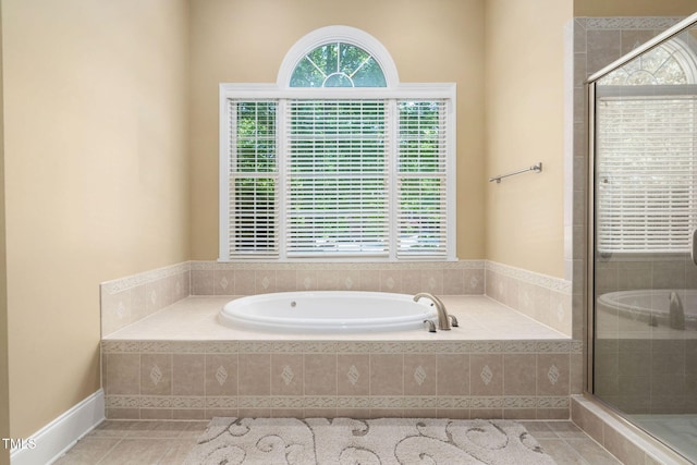 full bath with tile patterned floors, a shower stall, and a garden tub