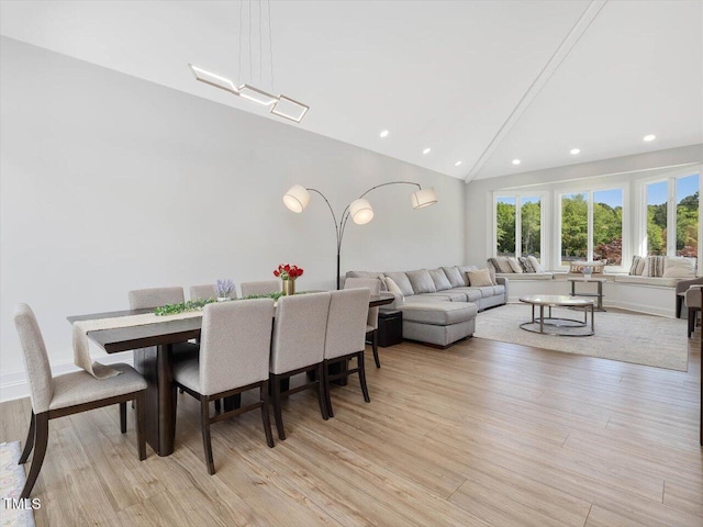 dining area with recessed lighting, light wood finished floors, and lofted ceiling