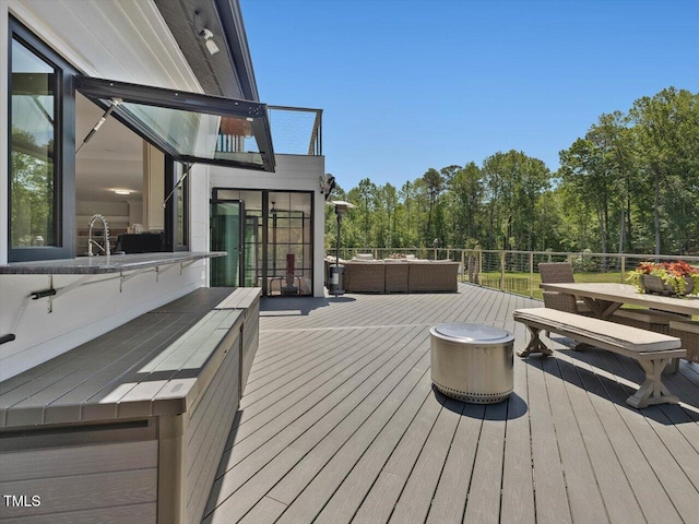wooden deck with an outdoor living space