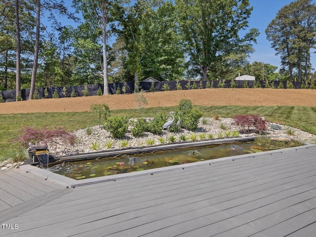 view of dock featuring a small pond and fence