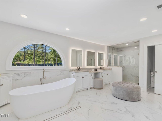bathroom with vanity, a marble finish shower, marble finish floor, recessed lighting, and a soaking tub