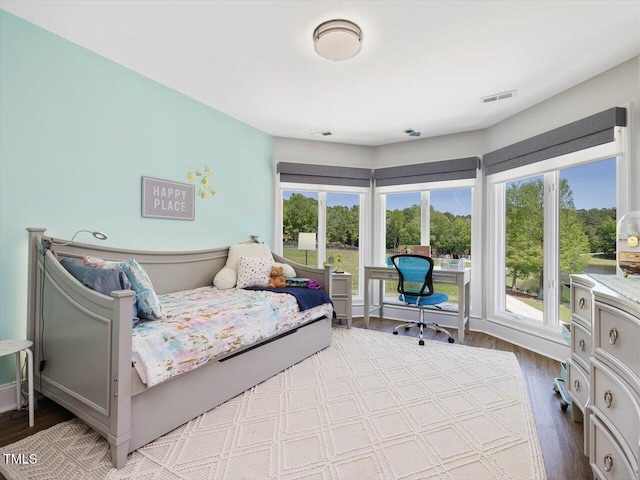 bedroom with wood finished floors and visible vents