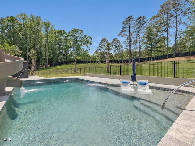 view of swimming pool featuring a lawn, fence, and a fenced in pool