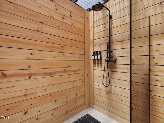 bathroom featuring speckled floor and tiled shower
