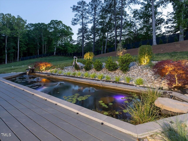 view of pool with a lawn