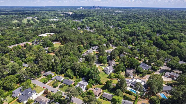 523 Vick Ave, Raleigh, NC 27612 - aerial overview of property's location with a forest and nearby suburban area