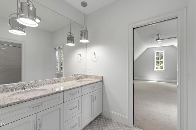 523 Vick Ave, Raleigh, NC 27612 - full bathroom featuring double vanity, a ceiling fan, baseboards, vaulted ceiling, and tile patterned flooring