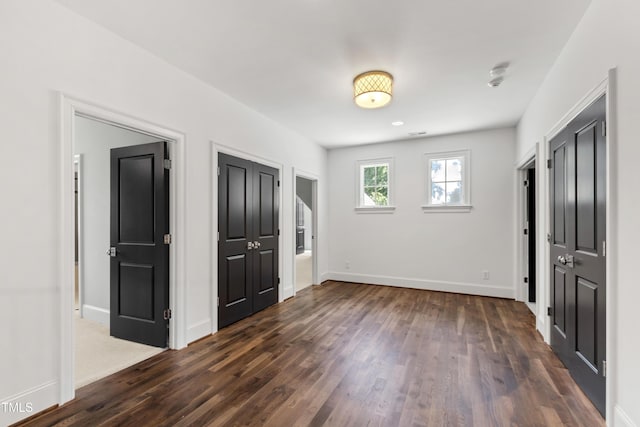 523 Vick Ave, Raleigh, NC 27612 - unfurnished bedroom featuring dark wood finished floors and baseboards