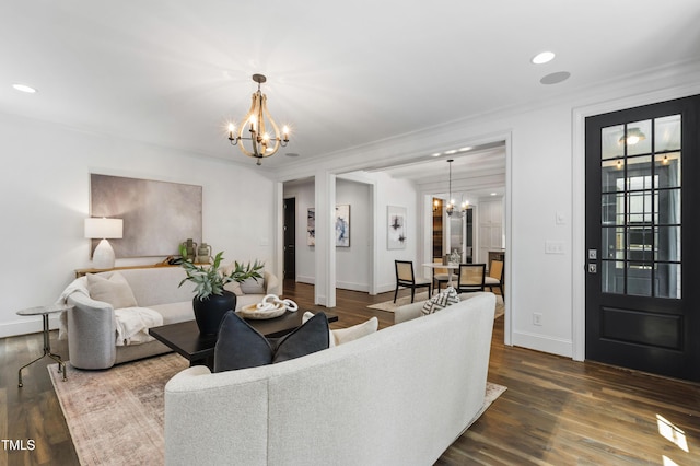 523 Vick Ave, Raleigh, NC 27612 - living room featuring a chandelier, baseboards, dark wood-type flooring, recessed lighting, and crown molding