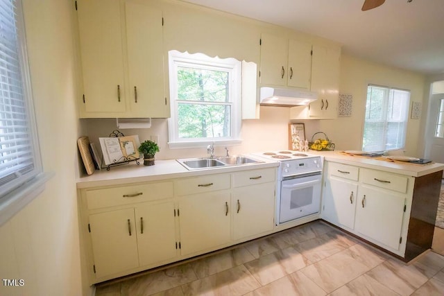 505 E Graham St, Mebane, NC 27302 - kitchen featuring under cabinet range hood, white electric stove, light countertops, and a peninsula