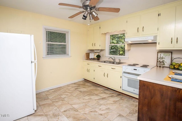 505 E Graham St, Mebane, NC 27302 - kitchen with white appliances, under cabinet range hood, light countertops, a ceiling fan, and cream cabinets