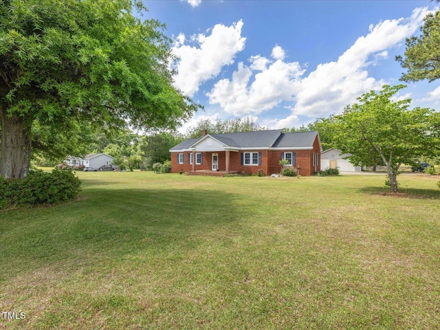 ranch-style home featuring brick siding, a front lawn, and a chimney