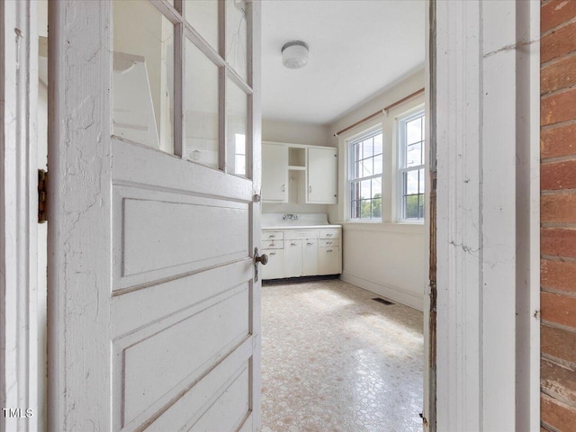 bathroom featuring tile patterned floors, visible vents, baseboards, and vanity