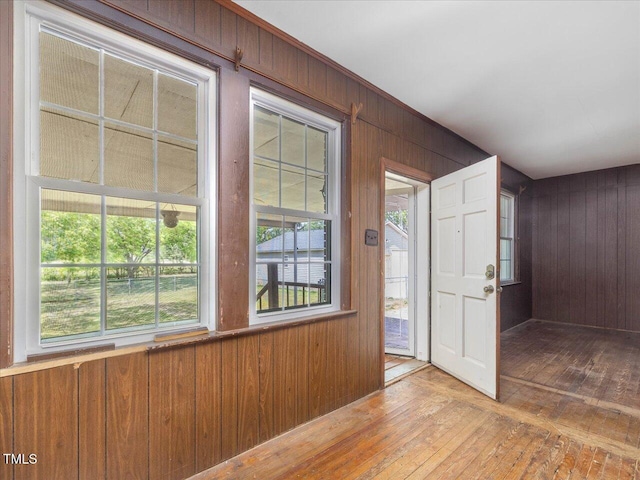 foyer featuring wooden walls and hardwood / wood-style flooring