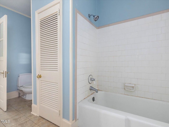 full bathroom featuring ornamental molding, toilet, baseboards, tile patterned floors, and  shower combination