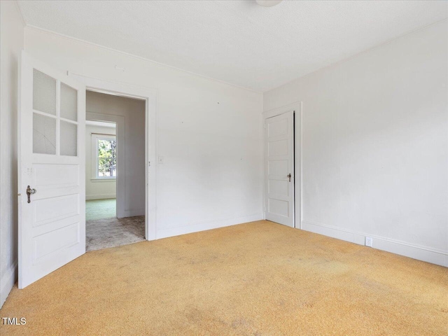 carpeted empty room with baseboards