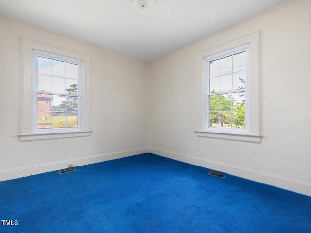 empty room with visible vents, carpet flooring, and baseboards