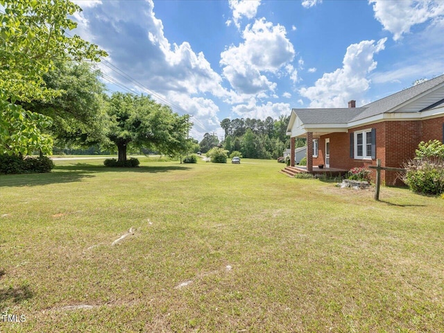 view of yard with covered porch
