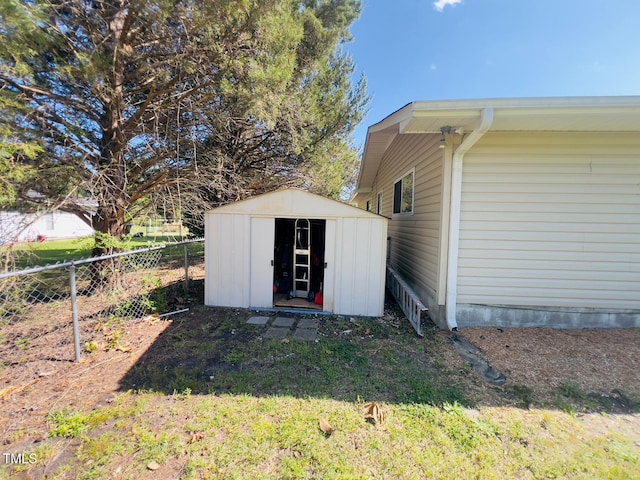 view of shed featuring fence