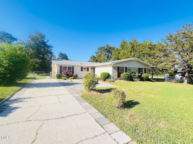 ranch-style home with a chimney, a gate, driveway, a front yard, and fence