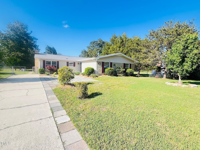 ranch-style house with a front lawn, a gate, and concrete driveway
