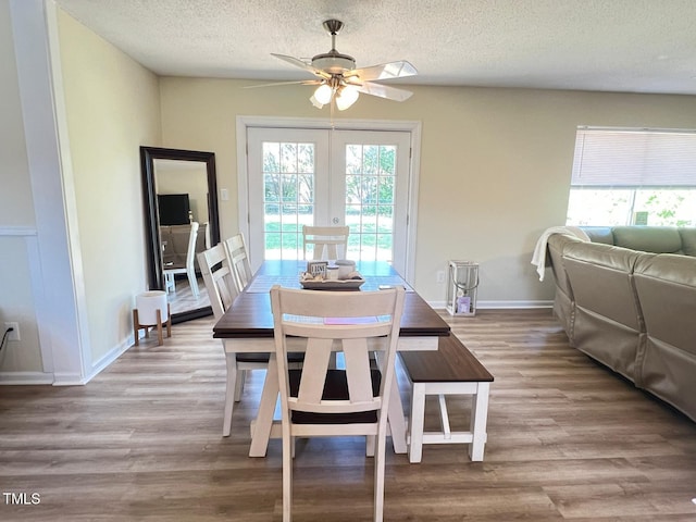 dining area with plenty of natural light, baseboards, a textured ceiling, and ceiling fan