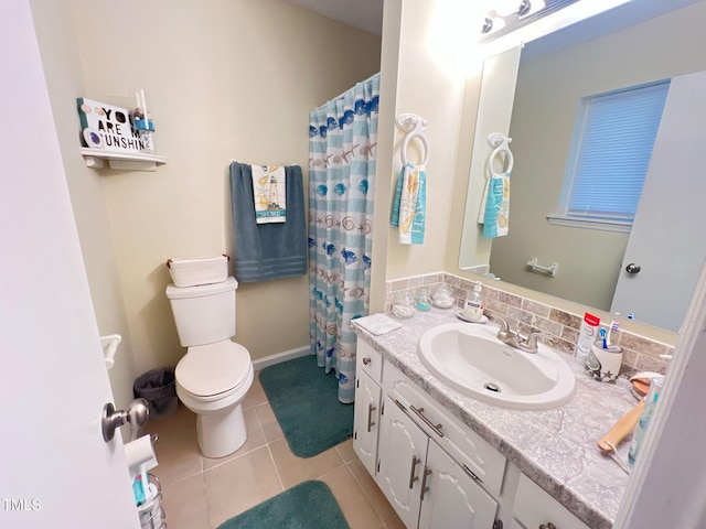 bathroom featuring toilet, vanity, a shower with shower curtain, and tile patterned flooring